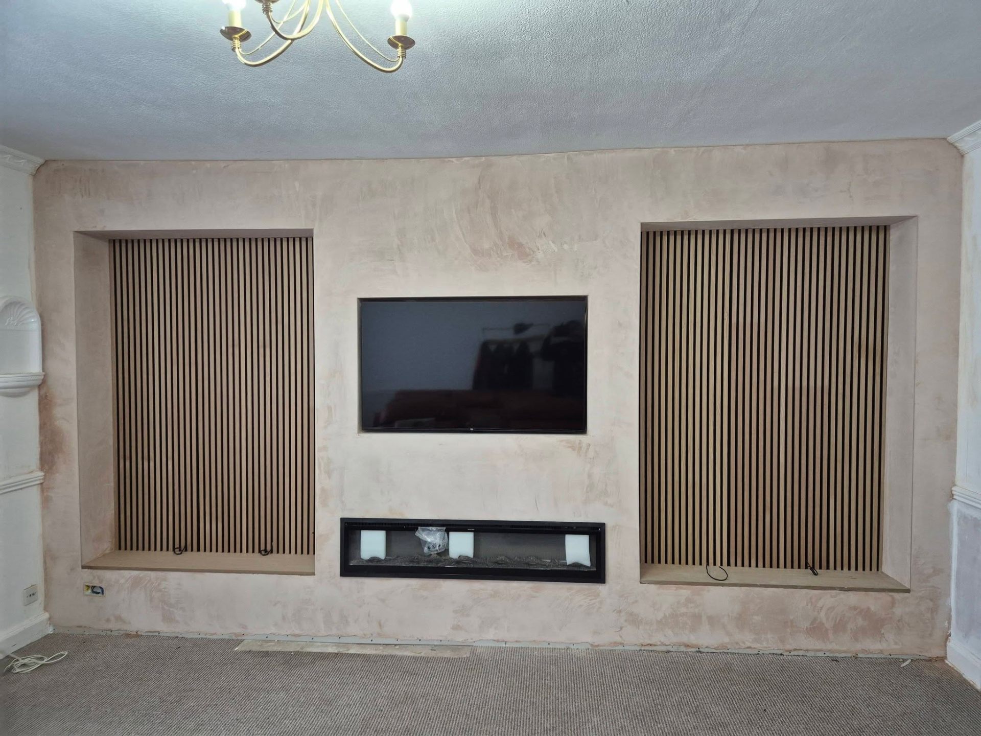 TV wall mounted between slatted panels with hidden cables in a Fife living room