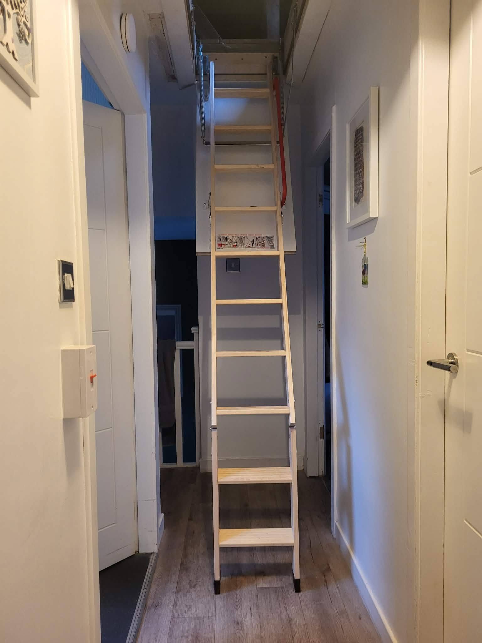 Wooden loft ladder fitted through a new loft hatch in a Fife home